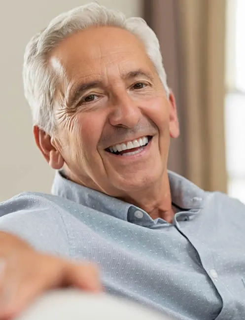 older man smiling with dentures